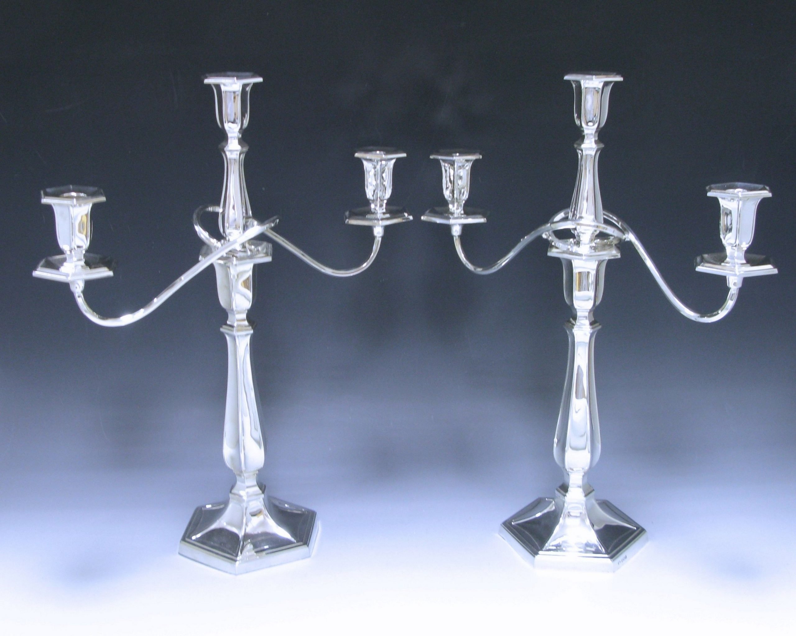 A pair of Silver three-light candelabra 1