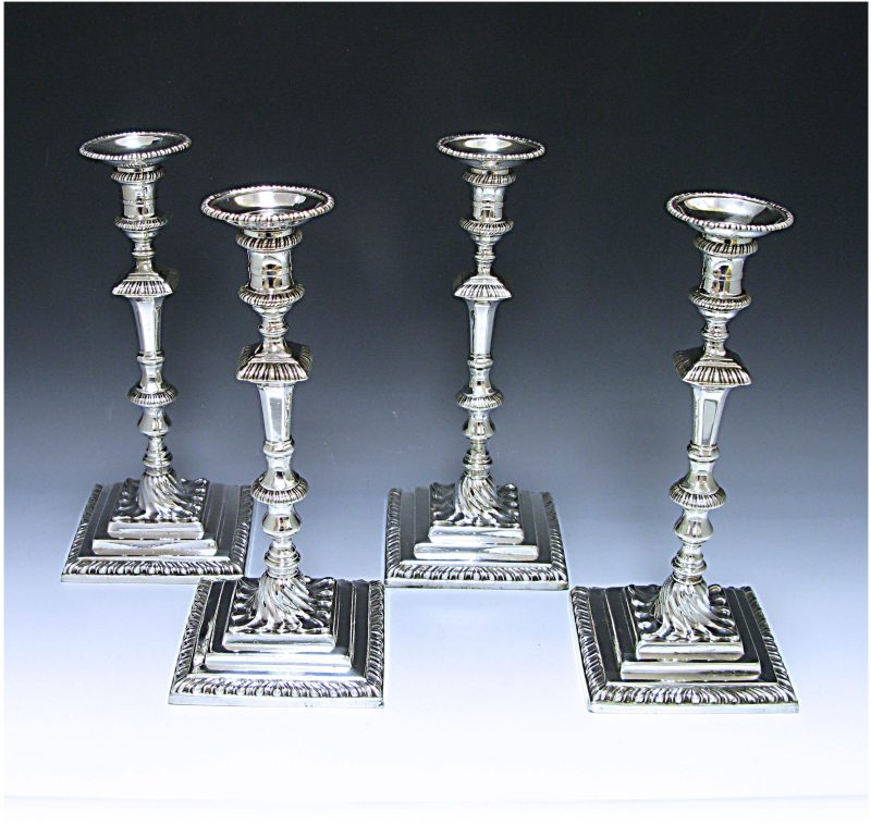 A set of Four George III Cast Sterling Silver Candlesticks