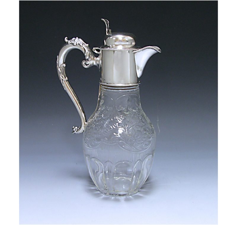 An Antique Silver and Glass Claret Jug